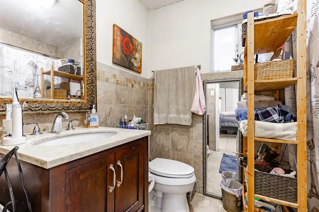 a bathroom with a sink a toilet and a mirror