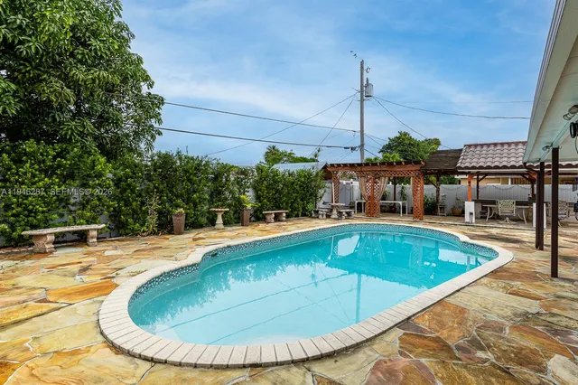a view of a swimming pool with a outdoor seating