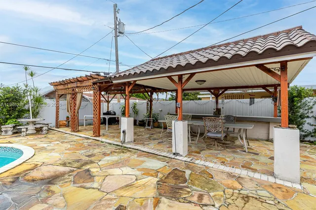 a patio with a table and chairs