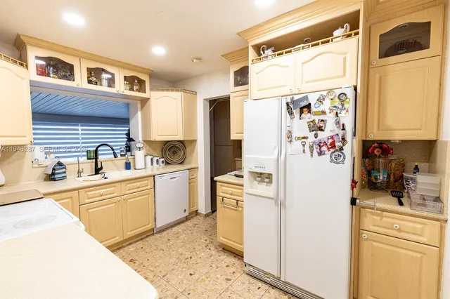 a kitchen with a refrigerator and a sink