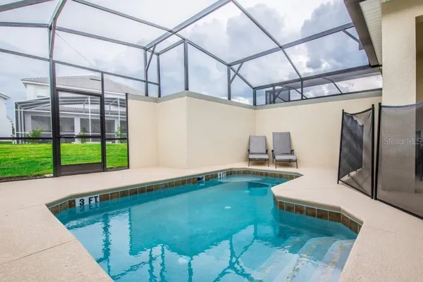 a backyard of a house with table and chairs