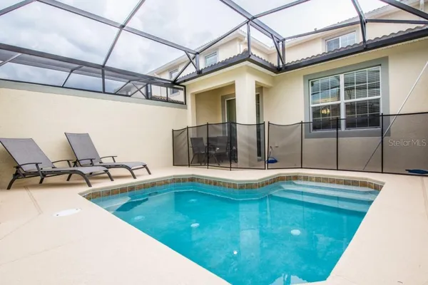 a swimming pool with outdoor seating and outdoor seating