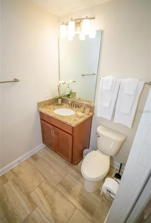 a bathroom with a toilet sink and mirror