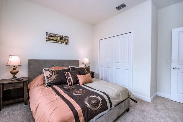 a bedroom with a bed and a lamp