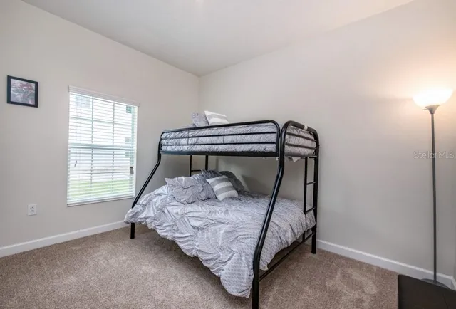 a bedroom with a bed window and a window