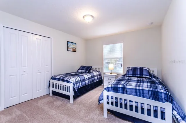 a bedroom with bed and a window