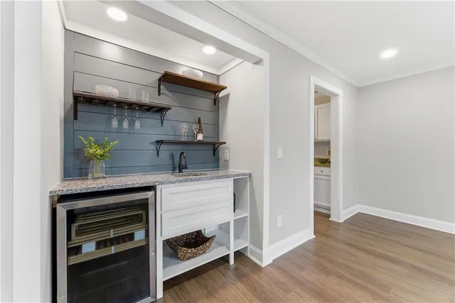 a kitchen with stainless steel appliances a stove and wooden floor