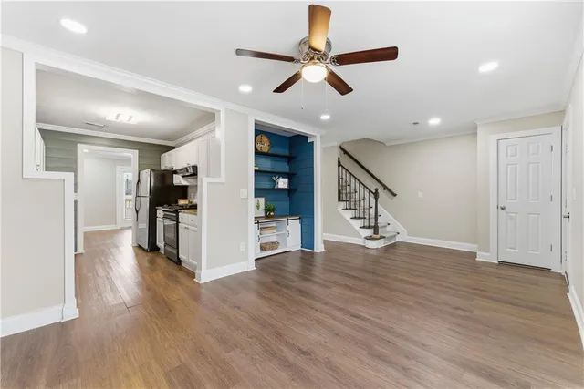 a view of a livingroom with wooden floor and furniture