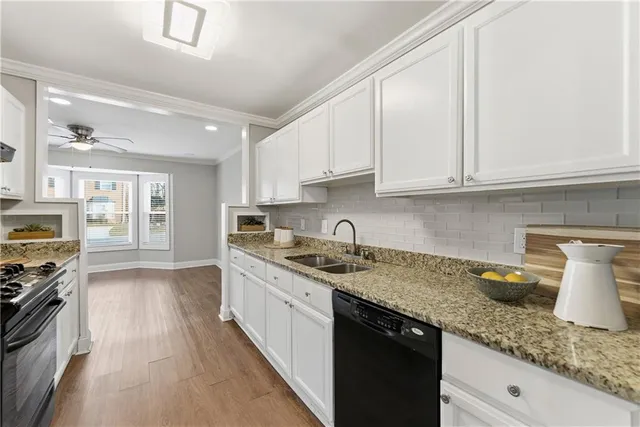 a kitchen with stainless steel appliances granite countertop a sink stove and cabinets