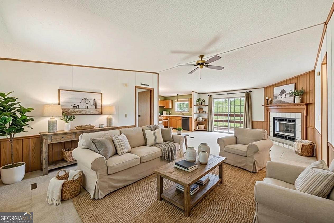 362 Horton Road Dahlonega, GA 30533 - Photo 11 of 57 a living room with furniture ceiling fan and a rug