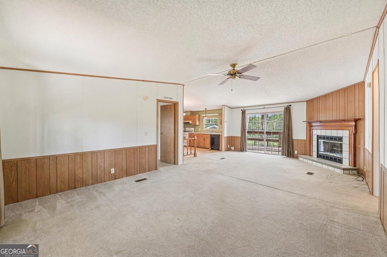 362 Horton Road Dahlonega, GA 30533 - Photo 12 of 57 a view of an empty room with a fireplace and a window