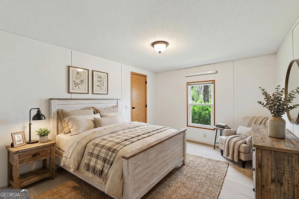 362 Horton Road Dahlonega, GA 30533 - Photo 23 of 57 a bedroom with a large bed and potted plant