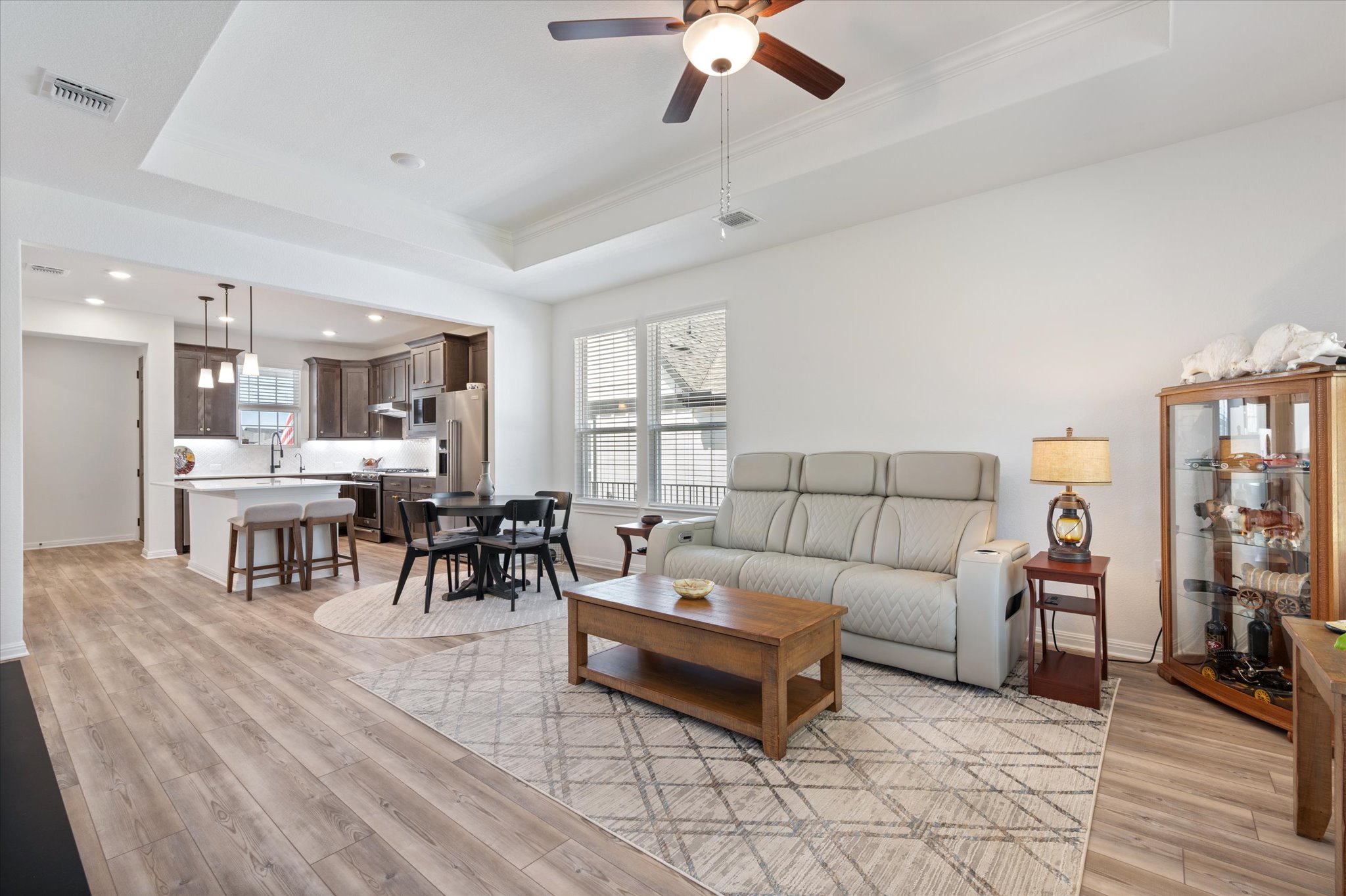 112 Clay Hl Street Georgetown, TX 78633 - Photo 13 of 29 a living room with furniture and a dining table with wooden floor