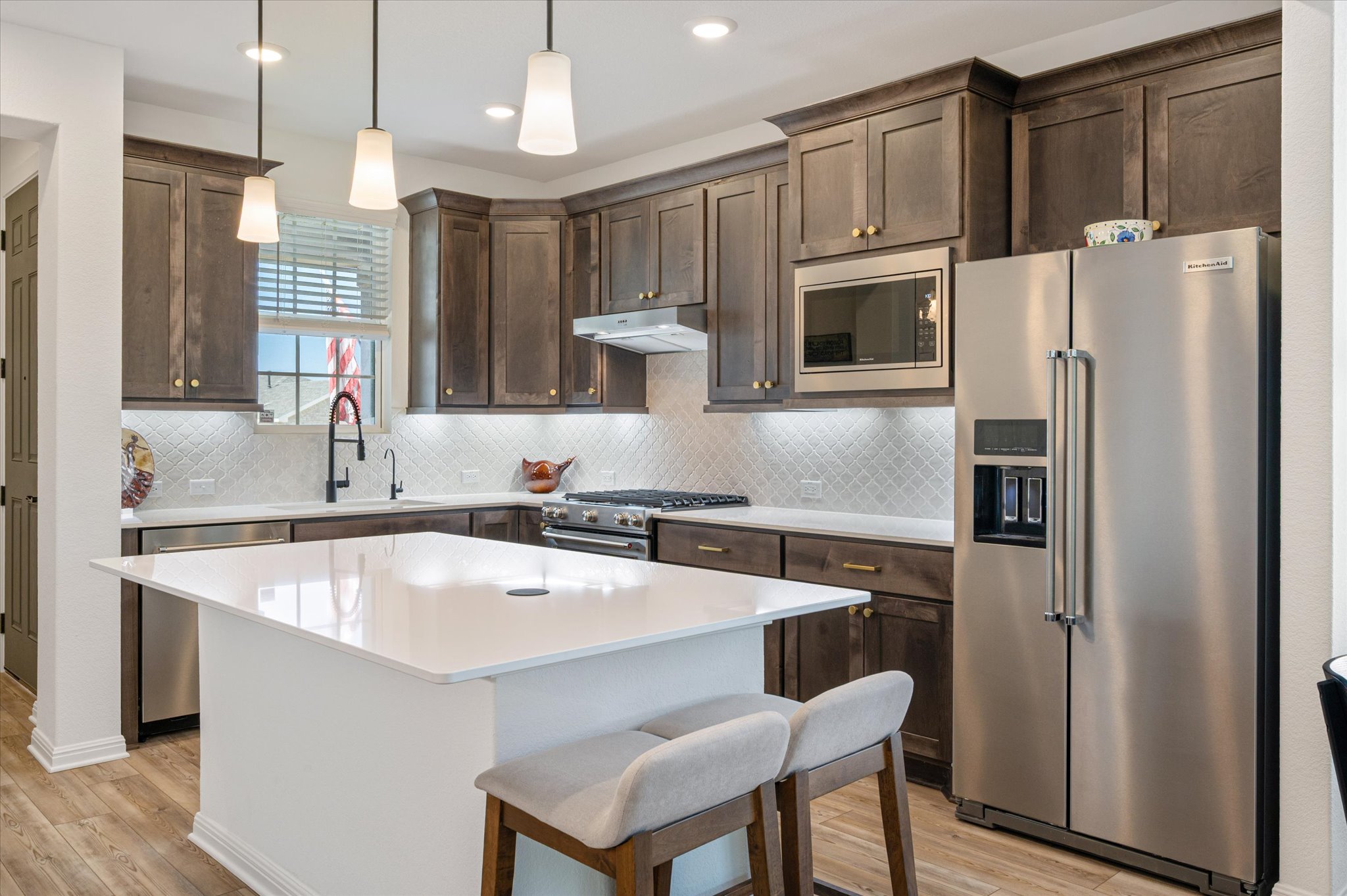 112 Clay Hl Street Georgetown, TX 78633 - Photo 5 of 29 a kitchen with stainless steel appliances a sink a stove a refrigerator and cabinets