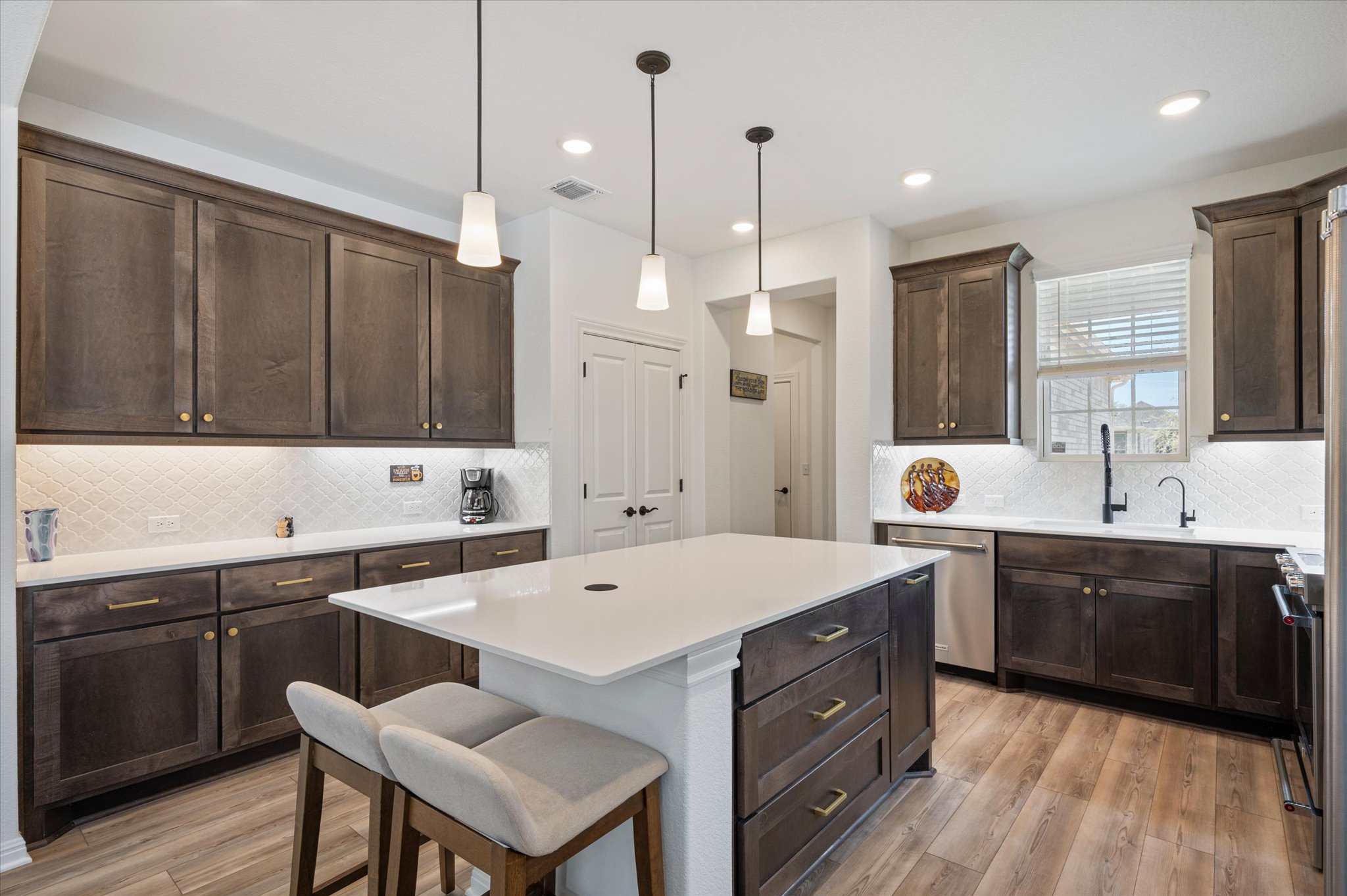 112 Clay Hl Street Georgetown, TX 78633 - Photo 8 of 29 a kitchen with a sink cabinets and wooden floor