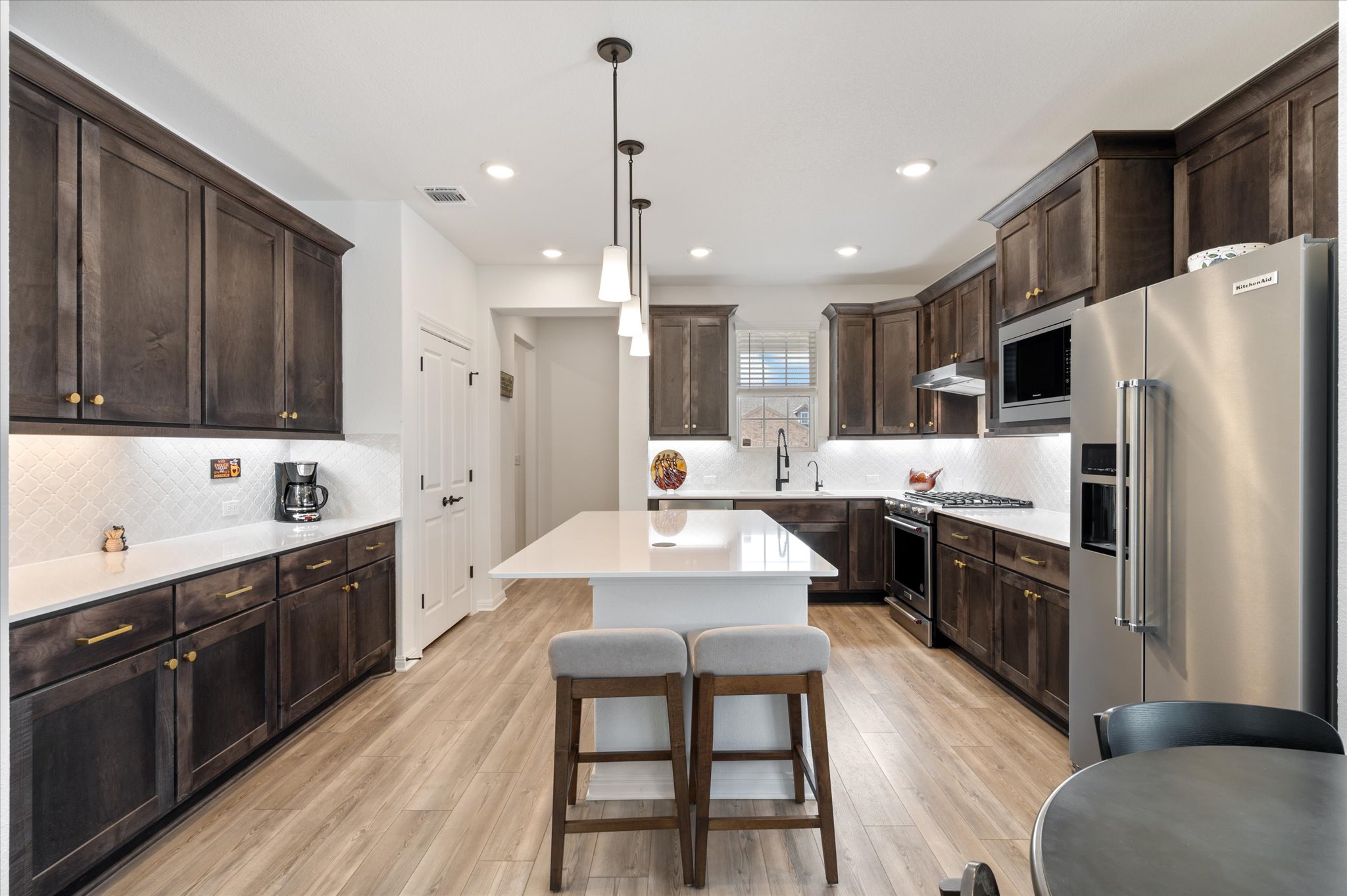 112 Clay Hl Street Georgetown, TX 78633 - Photo 9 of 29 a large kitchen with stainless steel appliances kitchen island granite countertop a dining table chairs sink and cabinets