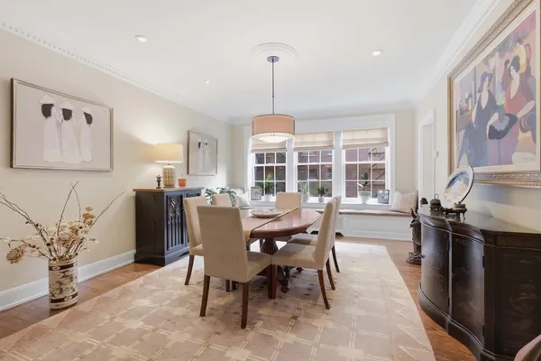 a dining room with furniture a chandelier and window