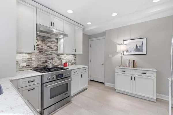 a kitchen with cabinets a sink and appliances