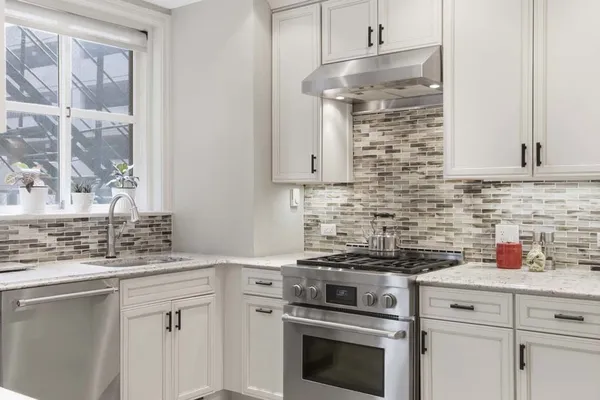 a kitchen with cabinets appliances and a sink