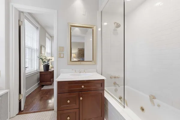 a bathroom with a bathtub and a sink