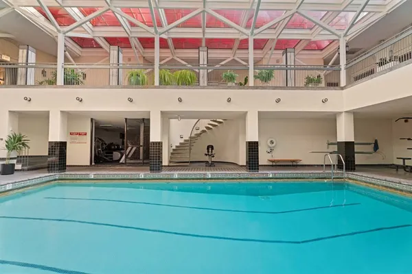 a view of a swimming pool with a bench and tables