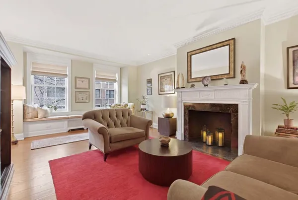 a living room with furniture fireplace and window