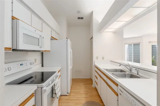 a kitchen with a sink and a stove top oven