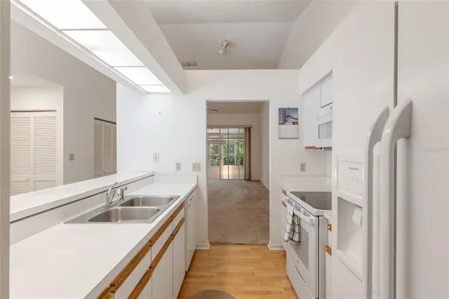 a kitchen with a sink and a refrigerator