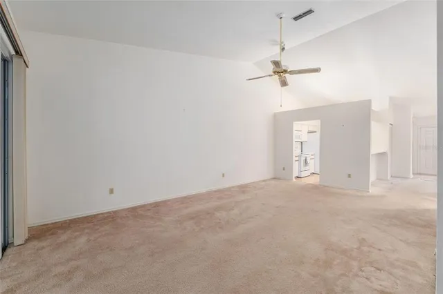 a view of an empty room with a ceiling fan