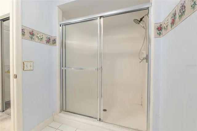 a bathroom with a glass shower door
