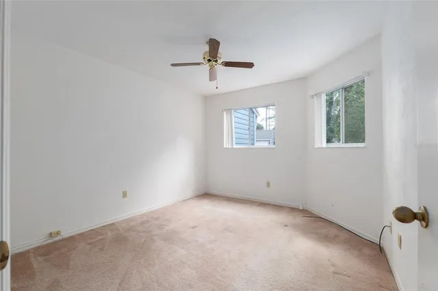 a view of empty room with ceiling fan