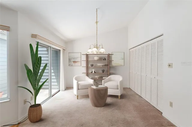 a dining room with furniture and a potted plant
