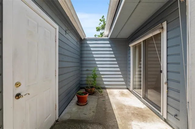 a view of small house with potted plants