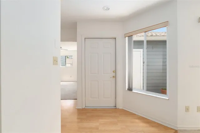a view of an empty room with closet and a window