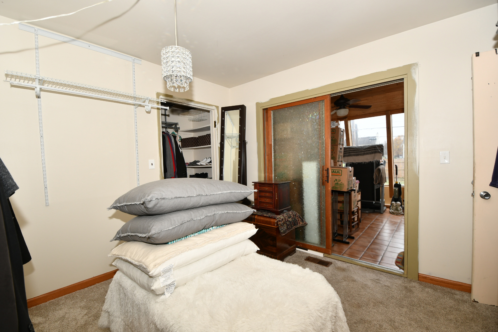 32 Saugatuck Road Montgomery, IL 60538 - Photo 22 of 28 a bedroom with a bed and a chandelier