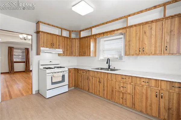 a kitchen with granite countertop white cabinets and white appliances