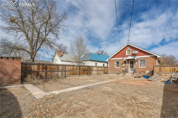 a view of a house with a yard and covered with snow