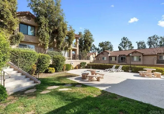 a view of a house with backyard and sitting area