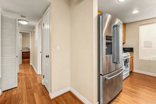 a view of hallway with wooden floor