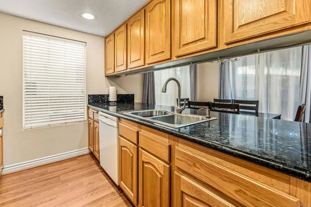a kitchen with granite countertop a sink and cabinets