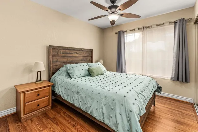 a bedroom with a bed dresser and a window