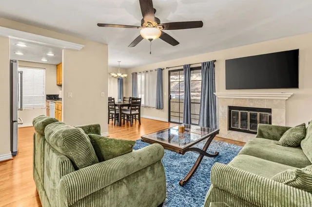 a living room with furniture fireplace and a flat screen tv