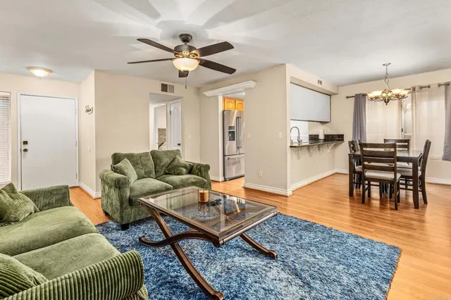 a living room with furniture and wooden floor