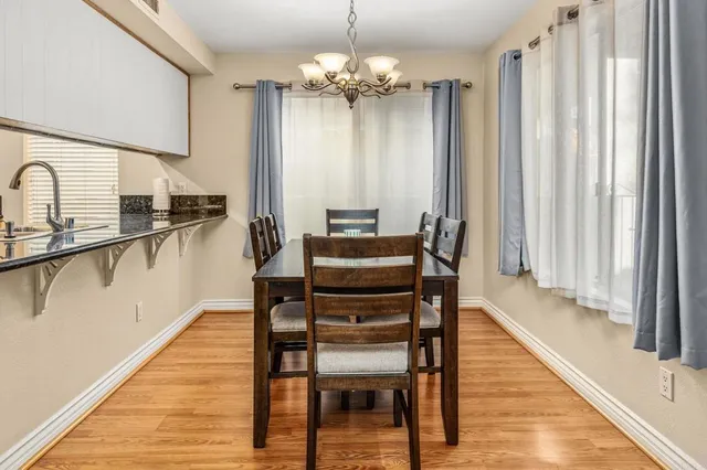 a dining room with furniture and wooden floor