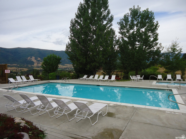 5168 Fairview Loop, Unit C604 Eden, UT 84310 - Photo 46 of 53 Community pool featuring a patio area and a mountain view