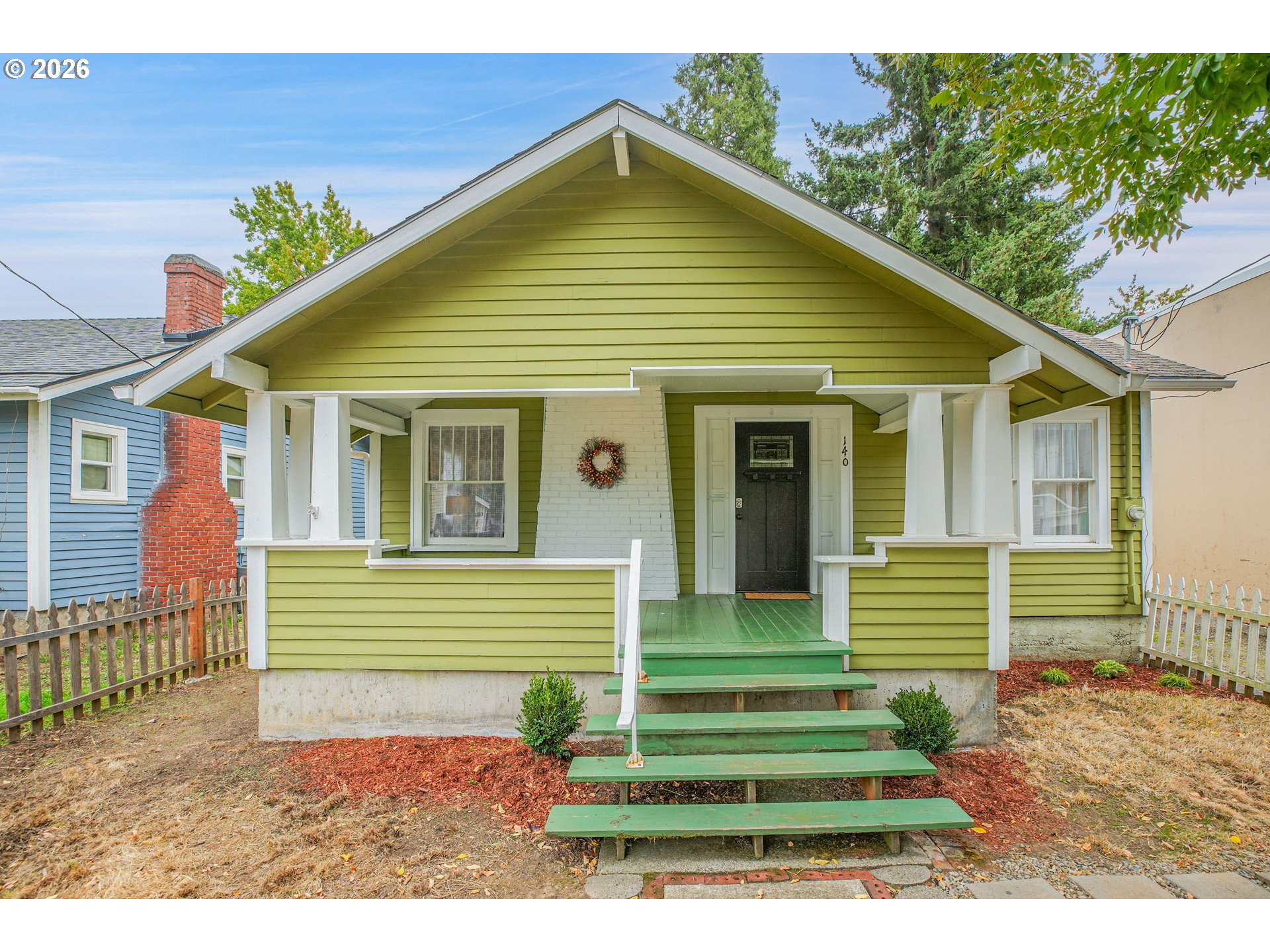 140 21st Street Northeast Salem, OR 97301 - Photo 2 of 44 a front view of a house with a garden