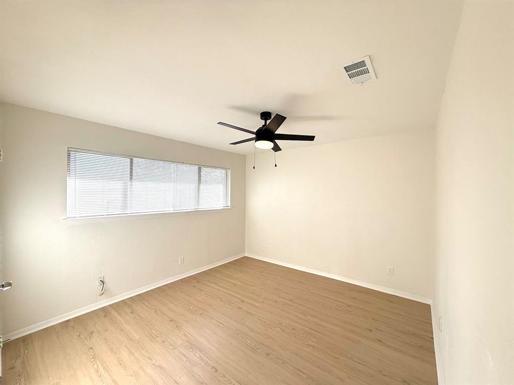 1401 Arvel Circle Azle, TX 76020 - Photo 14 of 26 a view of a room with wooden floor and a ceiling fan