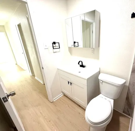 a white toilet sitting next to a bathroom sink