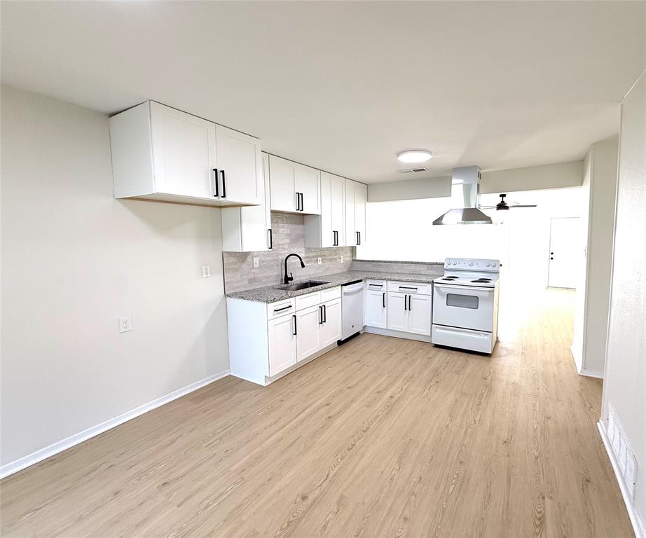 1401 Arvel Circle Azle, TX 76020 - Photo 2 of 26 a large kitchen with a white cabinets and wooden floor