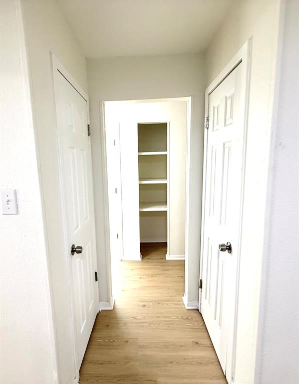 1401 Arvel Circle Azle, TX 76020 - Photo 21 of 26 a view of a hallway with wooden floor and closet